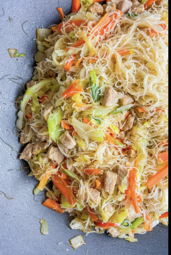 dish of rice noodle stir fry with chicken and vegetables